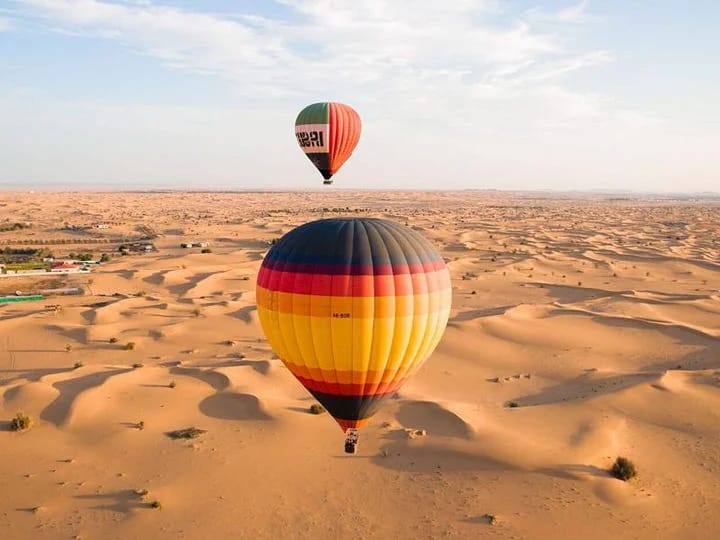 people enjoying hot air balloon ride over Dubai