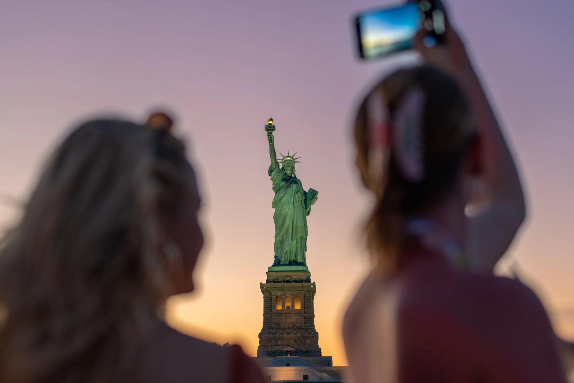 Women enjoying Statue at Sunset Cruise in New York