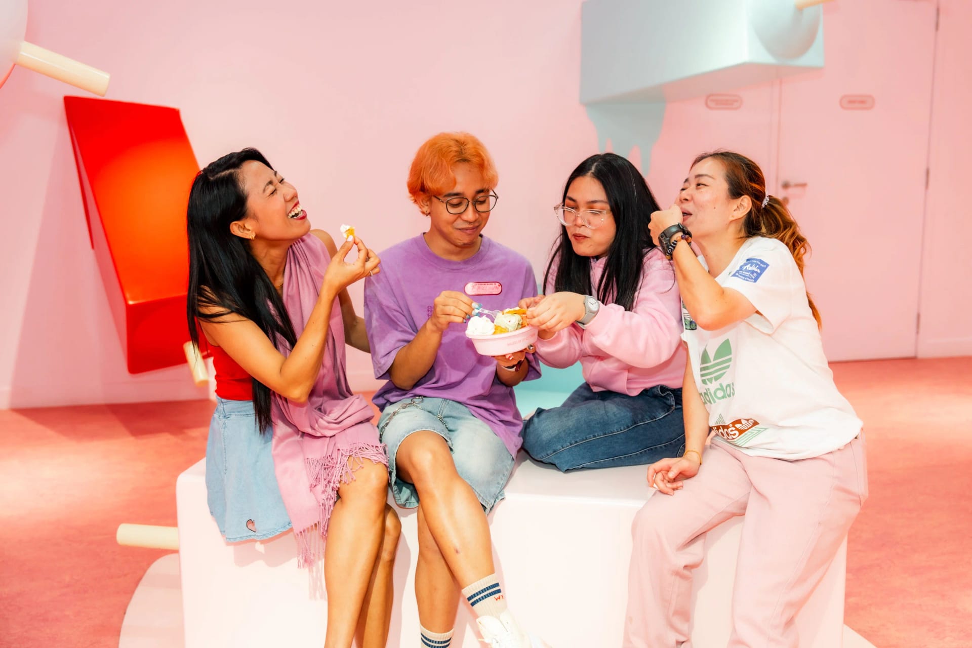Friends enjoying colorful treats at Museum of Ice Cream Singapore