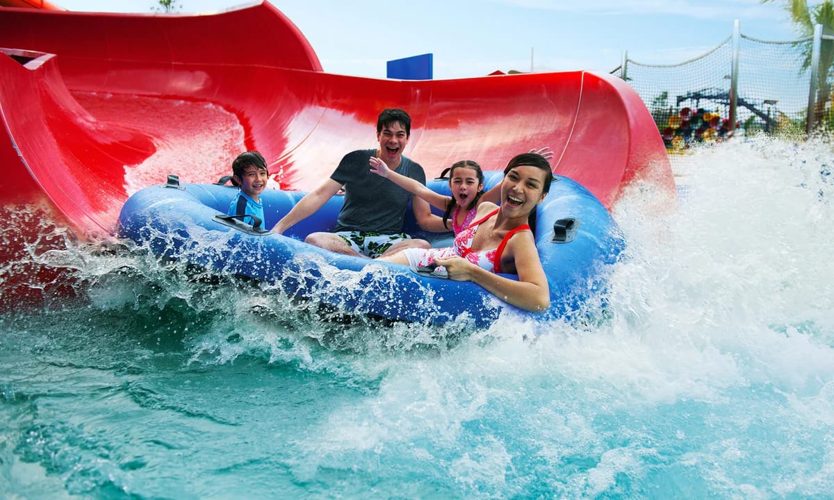 family enjoying LEGOLAND Water Park Dubai slide