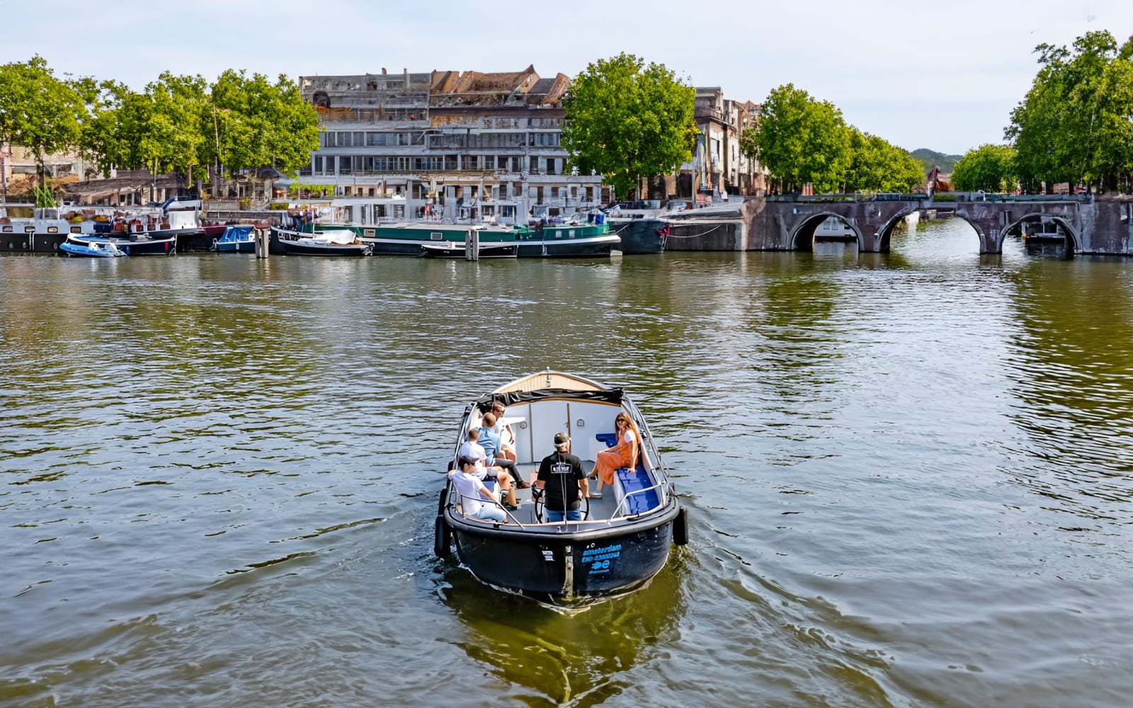 Amsterdam: 75-Minute Small Open Boat Canal Cruise experience tickets in Amsterdam | TickYourList