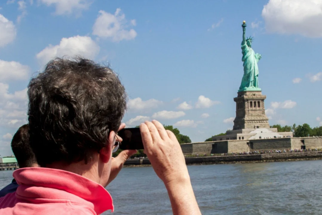 Tourist enjoying the Statue of Liberty cruise in New York